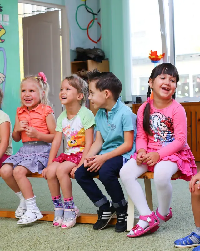Smiling children sitting together at circle time